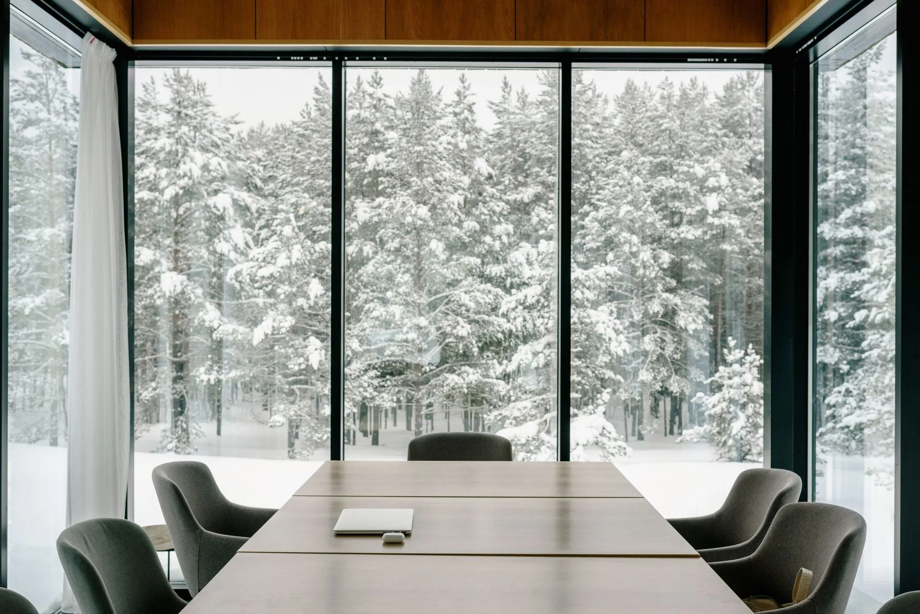 Sunlit contemporary meeting room with floor-to-ceiling windows
